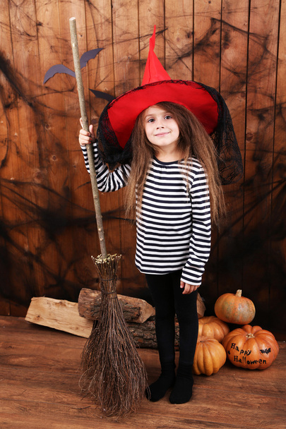 Little girl Witch in hat with broom on Halloween decorations background - Φωτογραφία, εικόνα