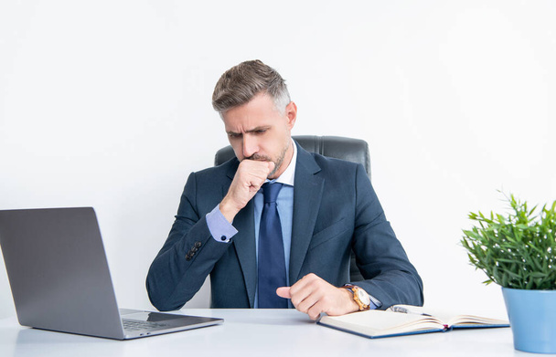 mature businessman sitting in business office having sore throat. - Zdjęcie, obraz