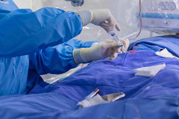 surgeon team working in operating room, Stem cells operation, Plasma in syringe, Health care concept. - Photo, Image