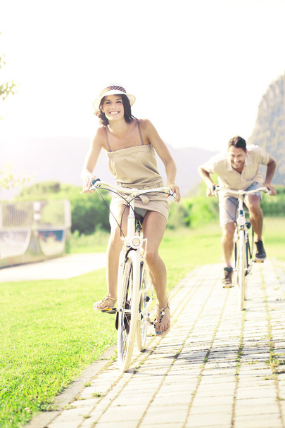 Couple in love have a ride with bicycles in the nature - Photo, Image