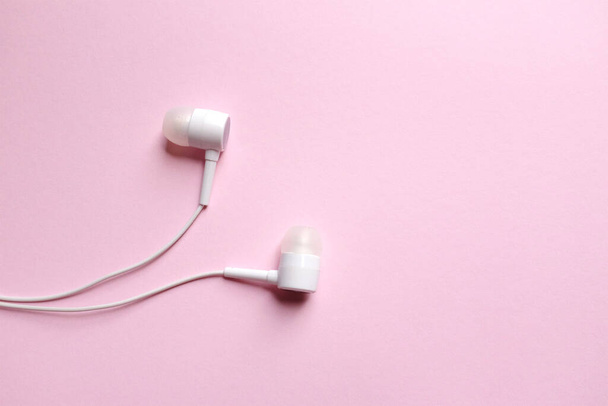 flat lay  white headphones,earphone,earbuds with headset on isolated pink pastel background - Photo, Image
