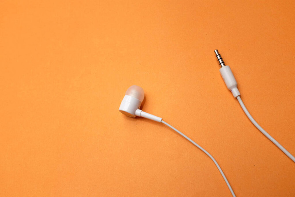 copy space white headphones,earphone,earbuds with headset on isolated orange background - Photo, Image