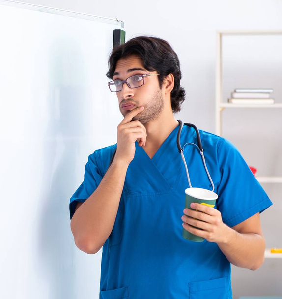 The young male doctor in front of whiteboard - Zdjęcie, obraz