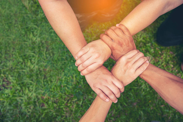 Top View Four hands Diverse multiethnic Partner team together. Close up Teamwork group of Four multiracial people join hands together. Above view Diversity people hand join partner team trust team - Φωτογραφία, εικόνα