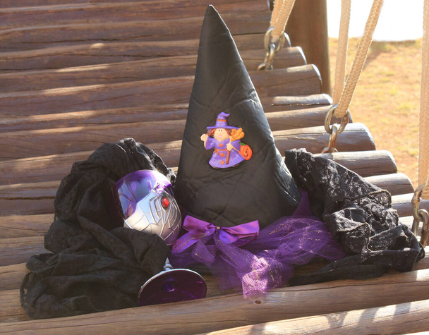 Ведьма черно-фиолетовая шляпа, вместе с чашкой паука в день Хэллоуина. - Фото, изображение