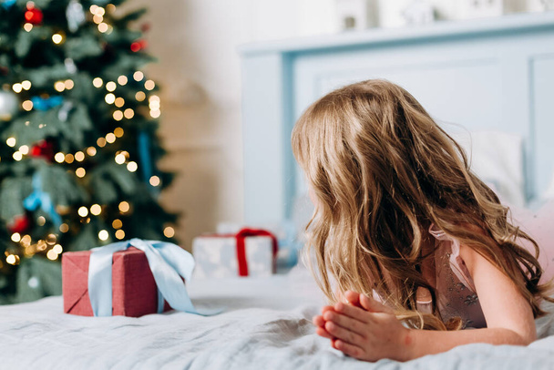 girls choose gifts boxes near christmas tree joy surpris - Valokuva, kuva