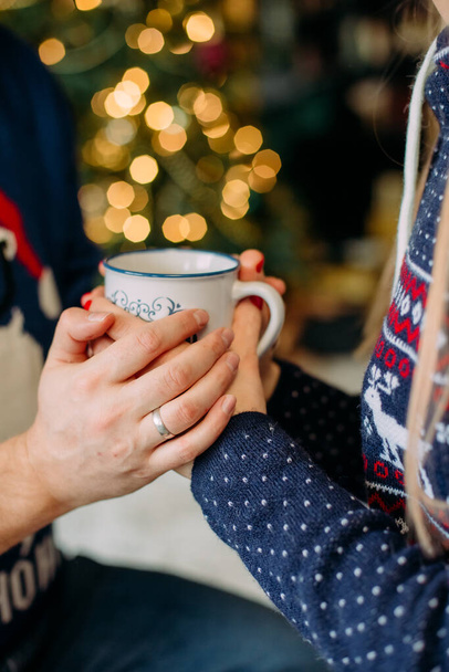 warm drink in a cup in the hands of lovers christmas evenin - Photo, Image