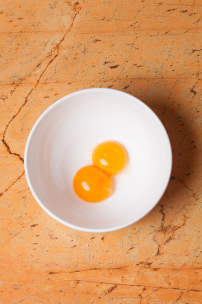 yellow egg yolks in a white bowl - Foto, immagini