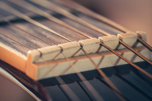 Guitar neck with metal string, macro shot with soft focus. - Photo, image