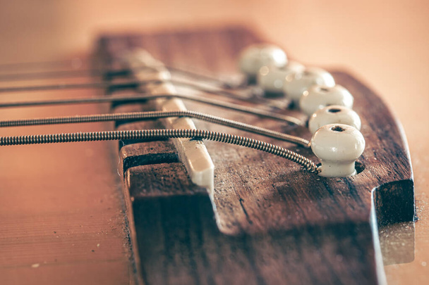 Strings on a classical acoustic guitar, macro shot. - Photo, image