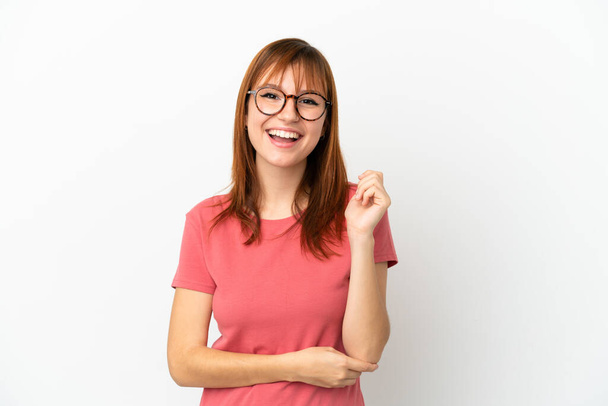 Redhead girl isolated on white background laughing - Photo, image
