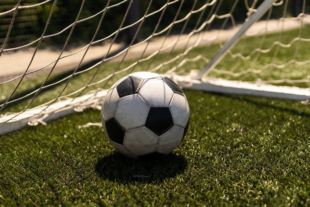 γκρο πλαν θέα δερμάτινη μπάλα ποδοσφαίρου για την πράσινη χλόη - Φωτογραφία, εικόνα