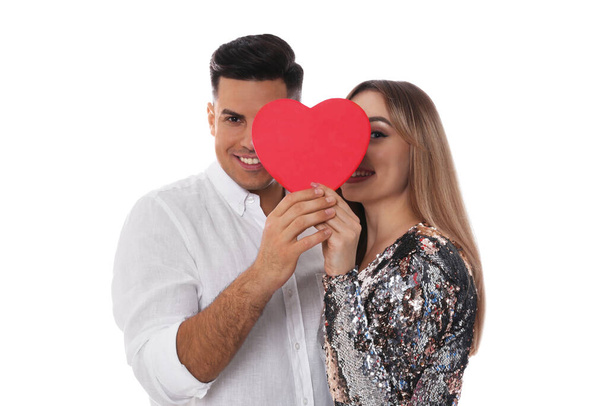 Lovely couple with decorative heart on white background. Valentine's day celebration - Foto, imagen
