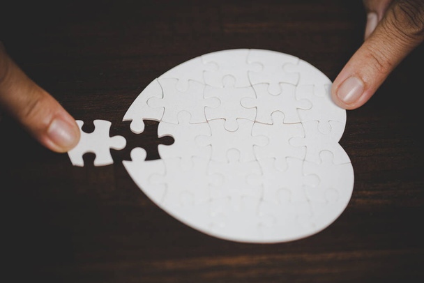 Business woman person hand with puzzle piece idea for strategy and solution. Closeup part of two white jigsaw connect together. Concept of join cooperation success teamwork-problem corporate team. - Foto, Imagem