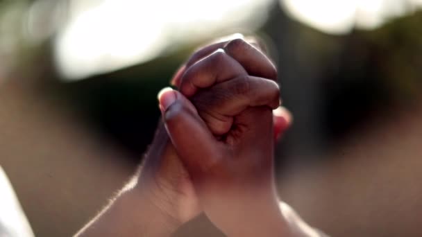 Two people joining hands together in the sunlight - Footage, Video