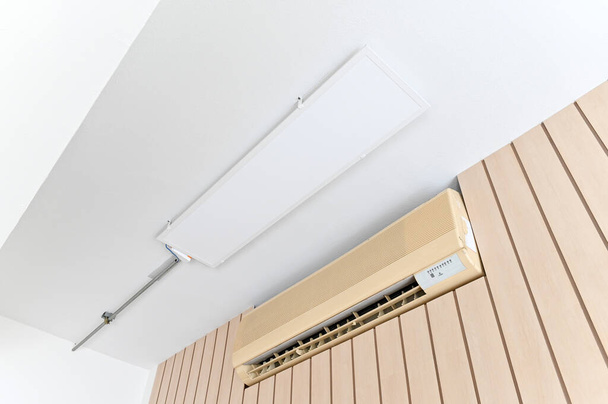 Air conditioner on brown wall room interior background. - Photo, Image