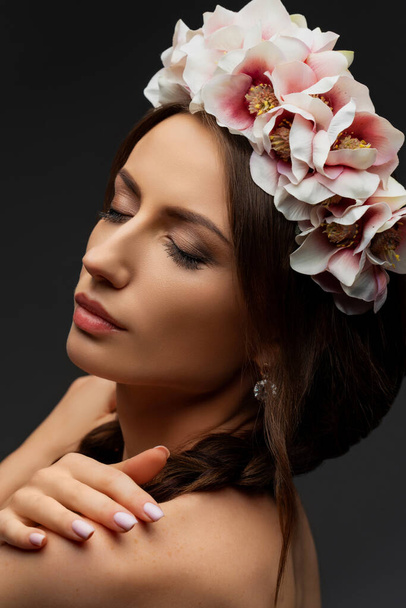 Beautiful young brunette woman wearing a delicately pink floral wreath. Wedding headdress for girls. Ukrainian beauty. High quality photo - Фото, зображення
