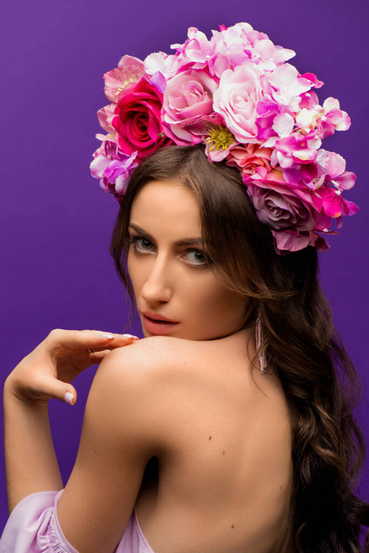Portrait of a Young Woman with Wreath of Pink Flowers on purple Background. Natural Beauty Concept. Ukrainian girl. Save Ukraine. High quality photo - Photo, image
