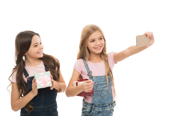 Have fun shooting selfies. Little models shooting selfies with mobile phone. Small girls taking photo shooting for sharing their images on social media. Adorable children enjoy their shooting session. - Photo, image