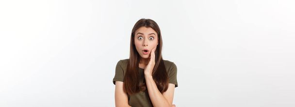 amazement - woman excited looking to the side. Surprised happy young woman looking sideways in excitement. Mixed race Asian and white Caucasian female model on grey background - Photo, Image