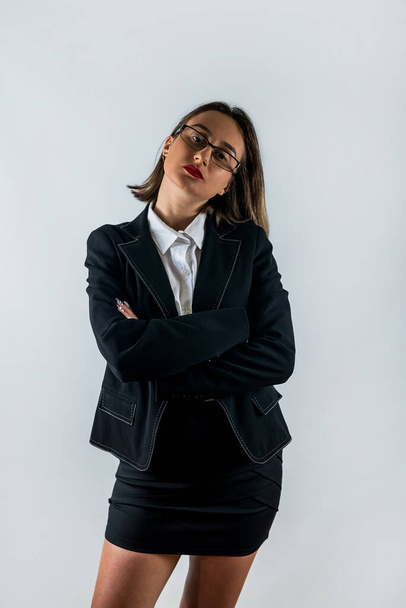 Portrait of happy smiling brunette businesswoman in black confident suit isolated over white background. Business studio concept. business woman boss - 写真・画像