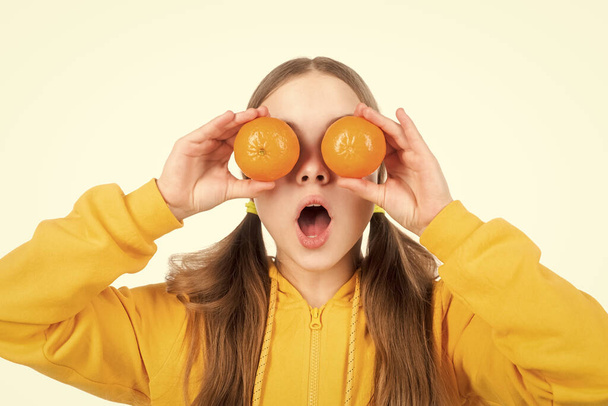 childhood health. citrus fruits. natural organic fresh orange. healthy life. diet and kid skin beauty. amazed teen girl with orange citrus fruit. vitamin and dieting. child eating healthy food. - Foto, immagini