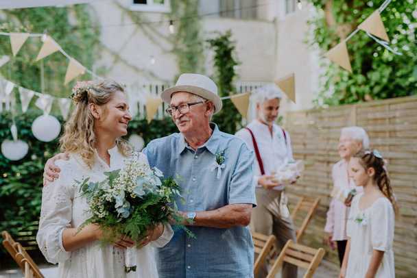 Mature bride with her dad at wedding garden ceremony. - Fotografie, Obrázek