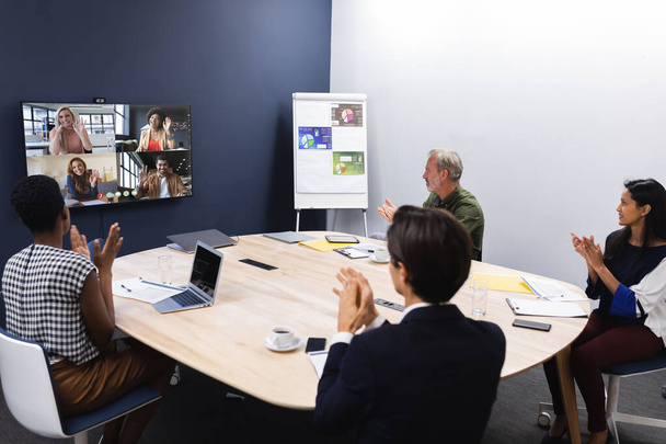 Diverse group of business colleagues having video call on screen in meeting room. work at a modern office. - Zdjęcie, obraz