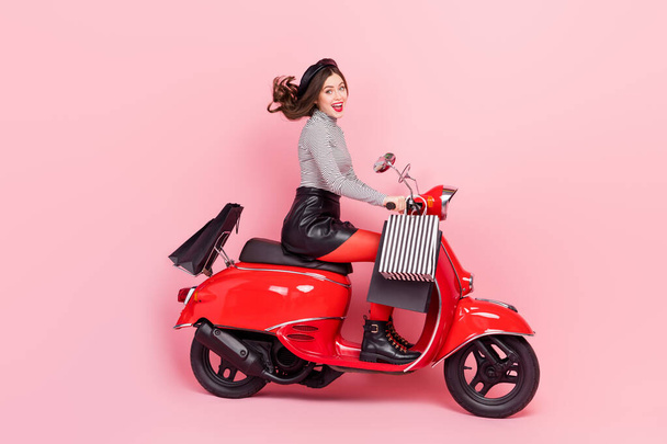 Profile side photo of extreme motor bike vehicle lady driver ride store stylish buyings offer isolated pink color background. - Zdjęcie, obraz