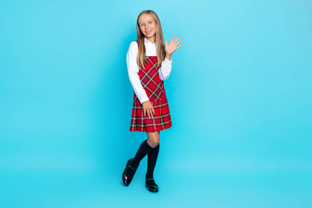 Full body size photo of little cute nice schoolgirl wear uniform showing five fingers hello world isolated on blue color background. - Фото, изображение