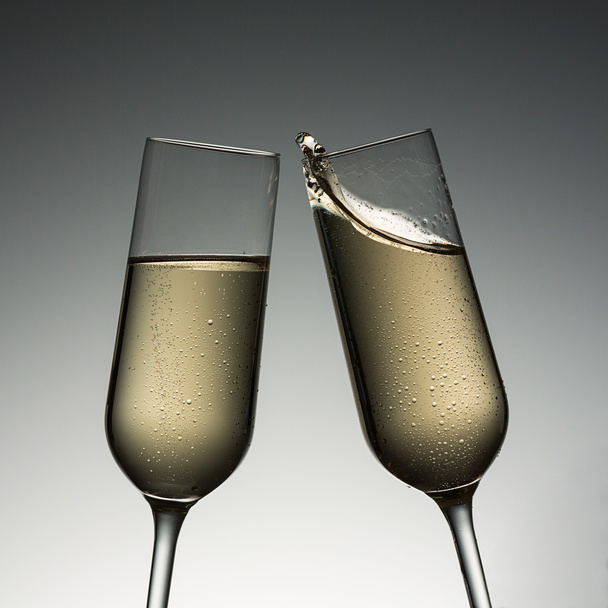 Clink glasses with champagne splash - Photo, Image