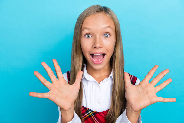Closeup photo of young little cute pretty schoolgirl hold palms crazy shocked good mood summer sale isolated on blue color background. - Fotó, kép