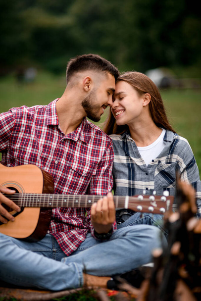 Close-up of lovely couple in love on romantic date at the park. Happy couple relationships. Romance couple with guitar. Love story. - Foto, Imagem