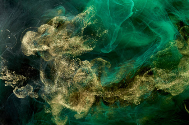 Golden sparkling abstract background, luxury green smoke, acrylic paint underwater explosion, cosmic swirling ink - Foto, imagen