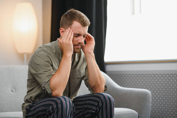Man having a headache at home. - Fotoğraf, Görsel