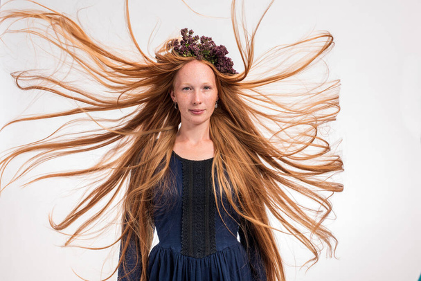 Portrait of woman with long explosive wavy red hair . - Zdjęcie, obraz