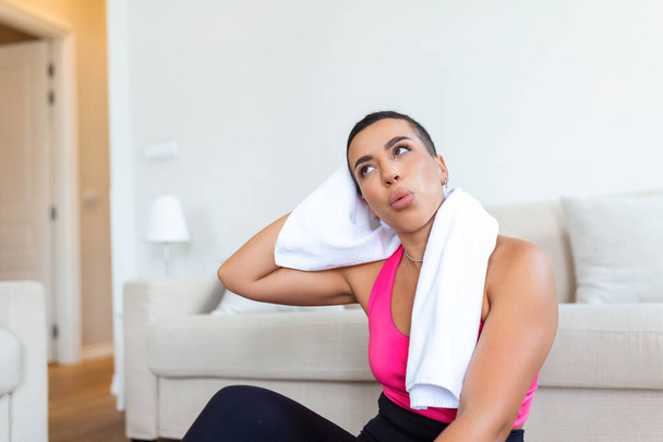 Fitness Model. Portrait of pretty smiling sporty black woman in sportswear having break after exercising with towel on her shoulders, looking away, free copy space - Photo, Image
