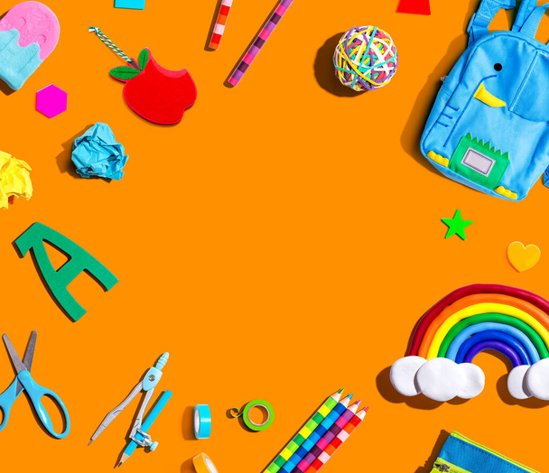 School supplies with a rainbow - overhead view - flat lay - 写真・画像