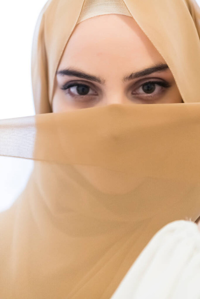 Portrait of young Muslim woman wearing hijab on isolated white background. High quality photo - Foto, afbeelding