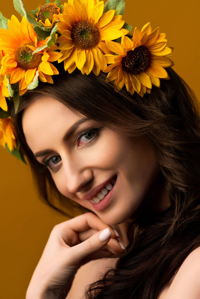 Portrait of a Ukrainian girl in a wreath of colorful yellow sunflowers. National traditional flower headdress. Ukraine concept. Stop war. High quality photo - Fotó, kép