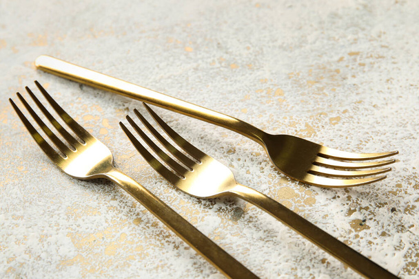Golden forks on grunge background, closeup - Photo, Image