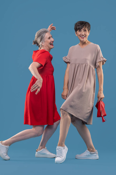 Happy women. Women in cute dresses having fun and looking happy - Valokuva, kuva