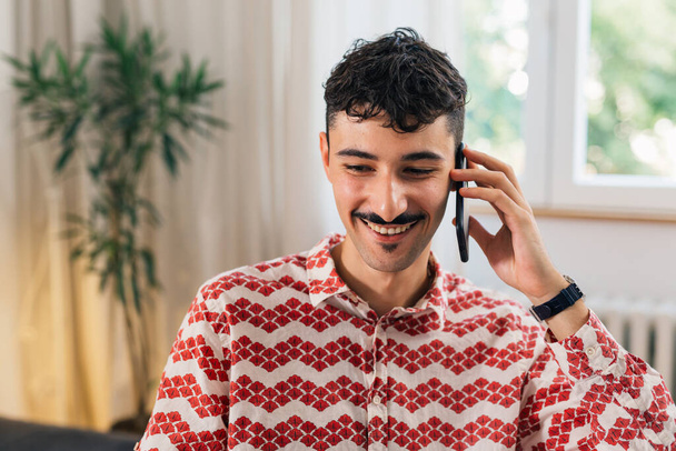 portrait of young man with mustaches talking on mobile phone - Fotoğraf, Görsel