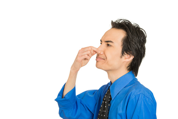 man disgust on his face pinches his nose, something stinks bad smell - Photo, Image