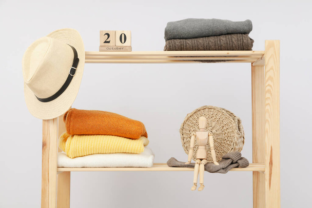 Wooden shelving with clothes, concept of autumn season clothes - Photo, Image