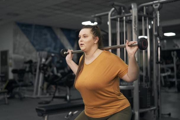 Kaukasierin mit Übergewicht im Gewichtheben - Foto, Bild