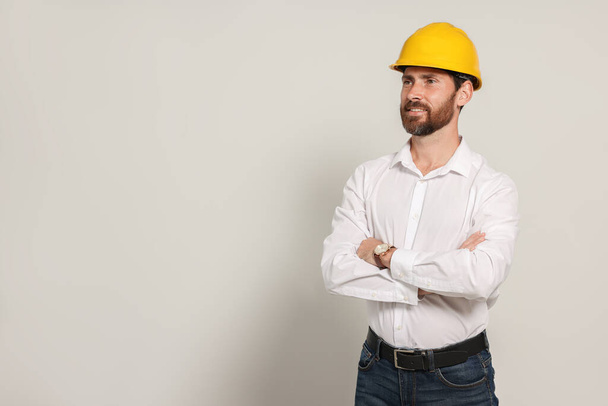 Professional engineer in hard hat on white background, space for text - Φωτογραφία, εικόνα