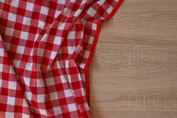Checkered picnic cloth on wooden table, top view. Space for text - Фото, зображення