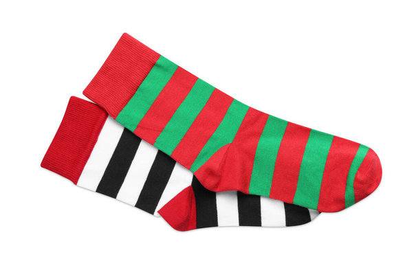 Different striped socks on white background, top view - Foto, Bild