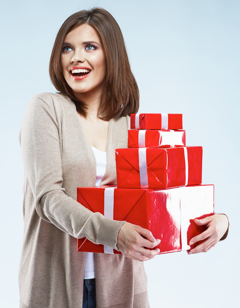 Woman holds red gift boxes - 写真・画像
